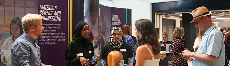 Group of people around an exhibition stand